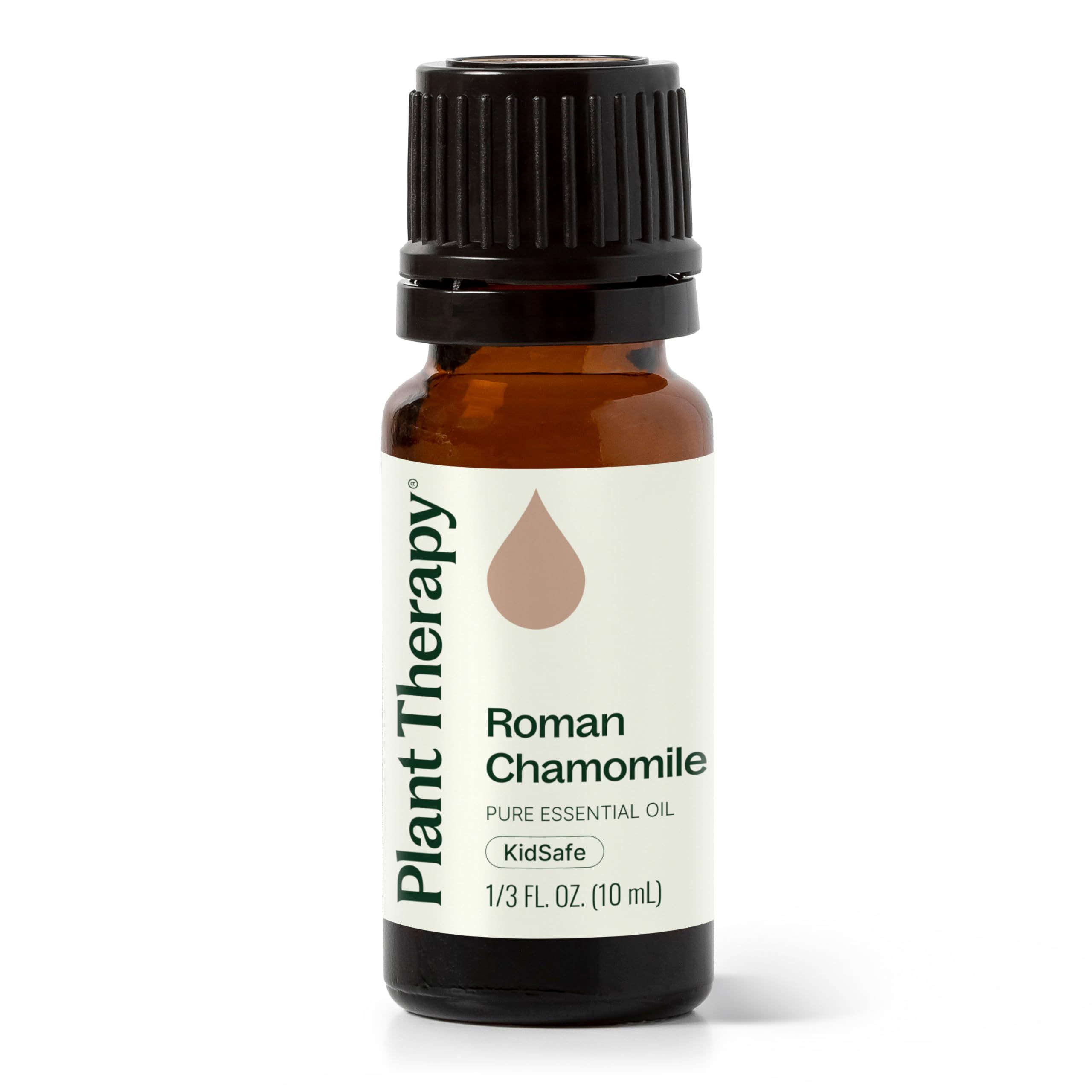 Roman chamomile essential oil bottle on a wooden surface with chamomile flowers