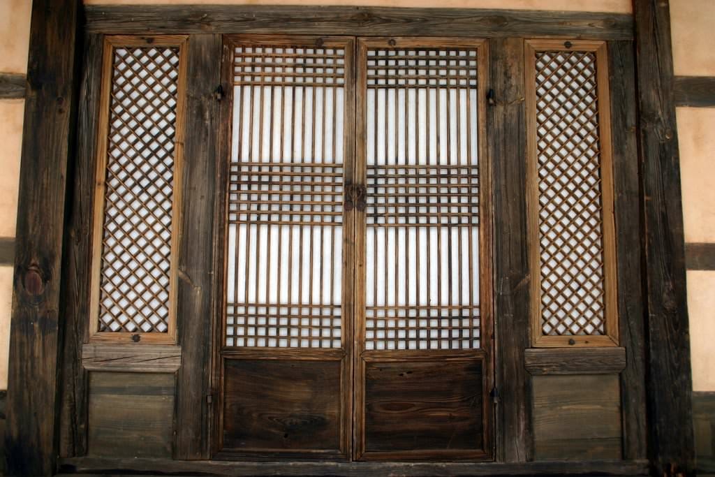 Traditional Korean hanji paper window with morning sunlight filtering through in hanok