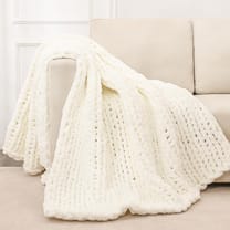 Chunky knit throw blanket draped over sofa