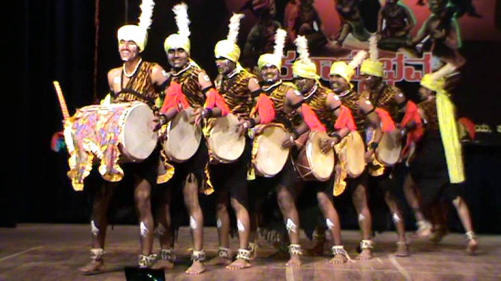 Dollu Kunitha dancers in colorful traditional costumes