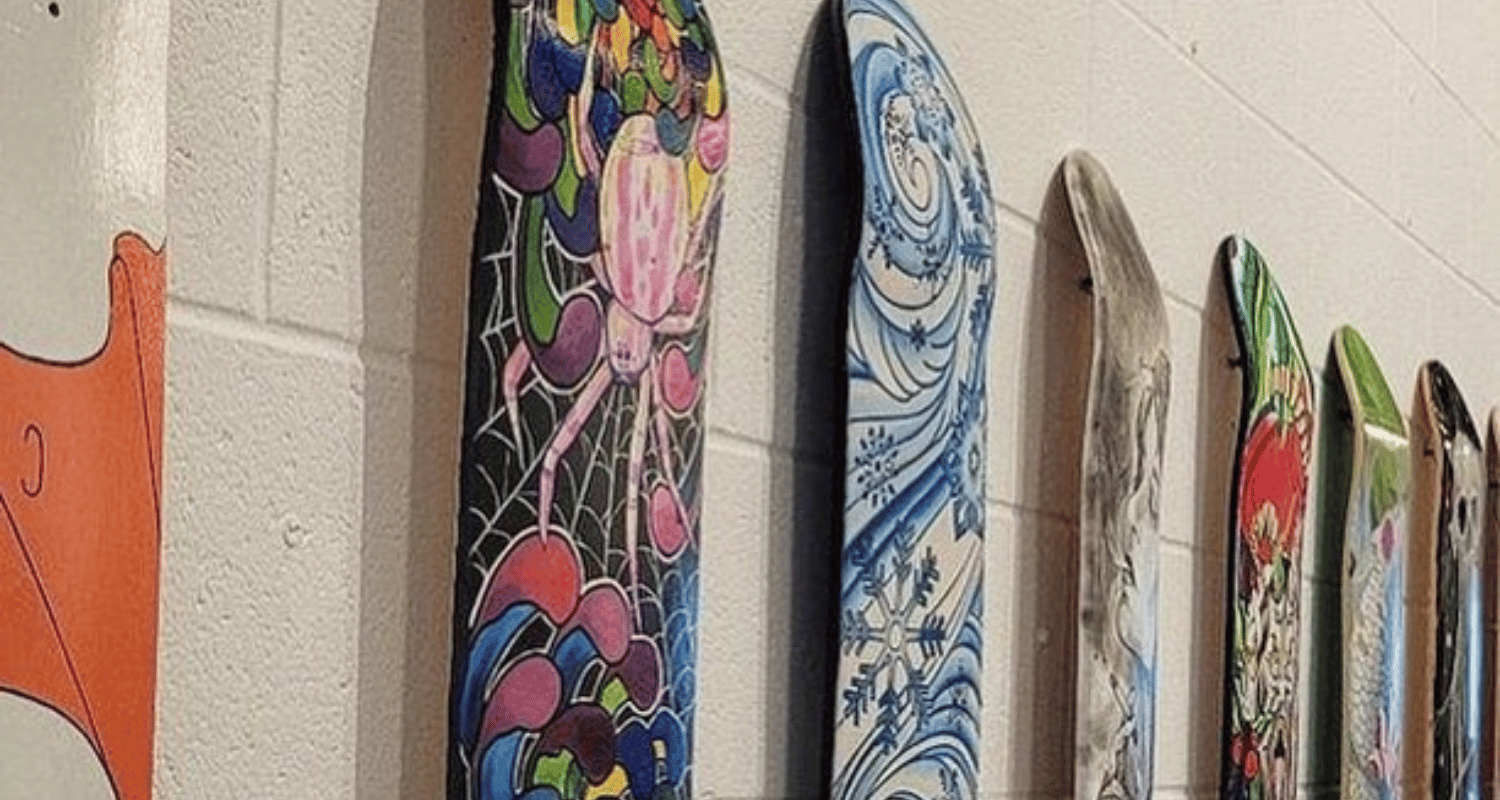 Close-up detail of American skateboard art deck showing vibrant street art design and premium maple construction